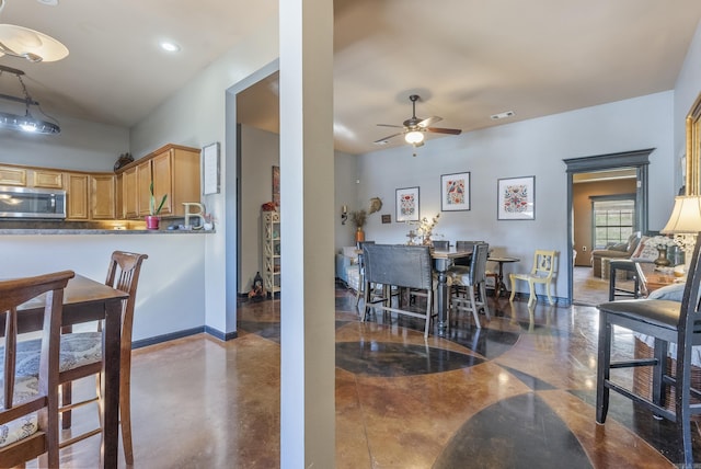 dining space featuring visible vents, a ceiling fan, recessed lighting, concrete floors, and baseboards