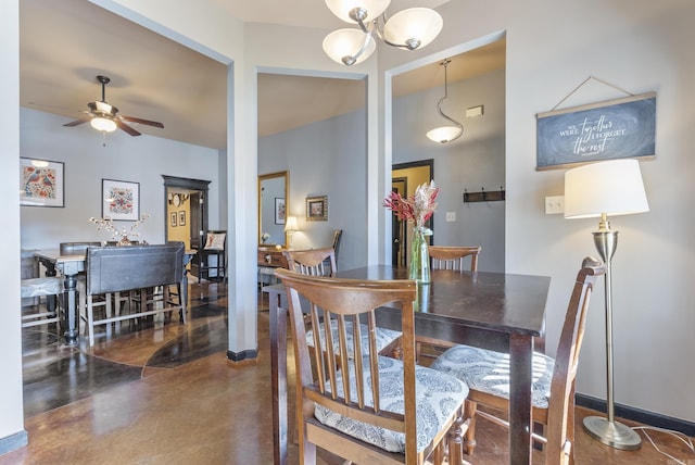 dining area featuring baseboards, finished concrete flooring, and ceiling fan