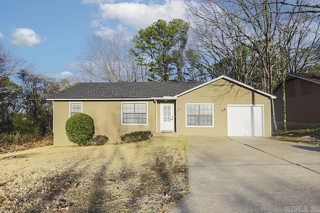 ranch-style home featuring a garage and driveway