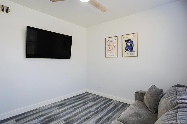 unfurnished room featuring visible vents, baseboards, dark wood-style floors, and ceiling fan