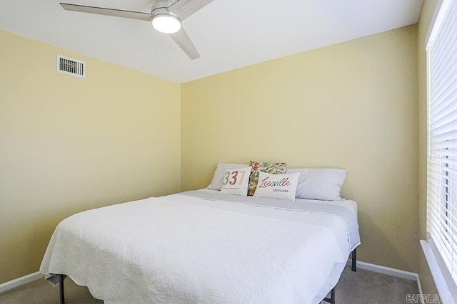 carpeted bedroom featuring visible vents, baseboards, and a ceiling fan