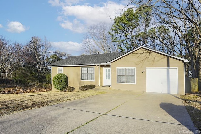 single story home featuring a garage and driveway