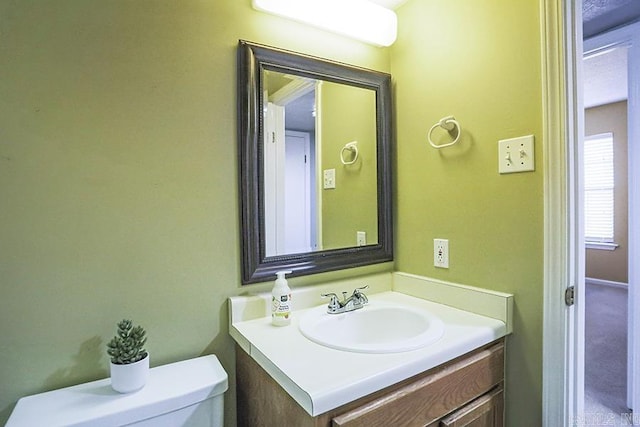 bathroom featuring toilet and vanity