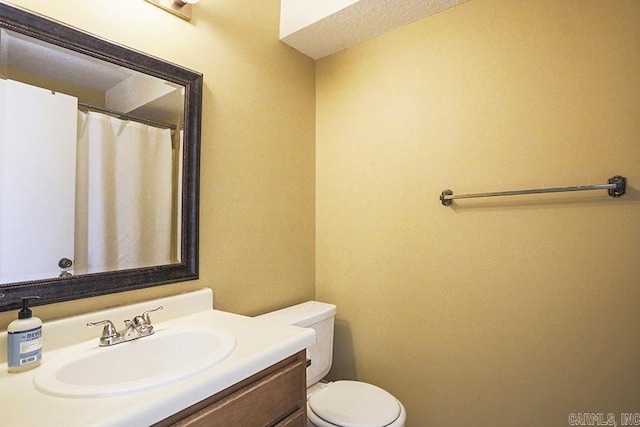 bathroom featuring toilet and vanity