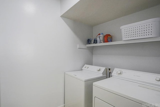 clothes washing area featuring laundry area and washing machine and dryer