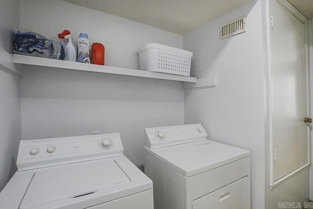 laundry room with independent washer and dryer, laundry area, and visible vents