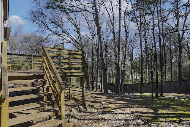 view of yard featuring stairway, a deck, and fence