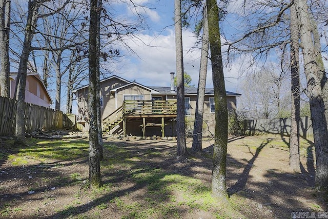 rear view of property featuring stairs, a fenced backyard, and a wooden deck