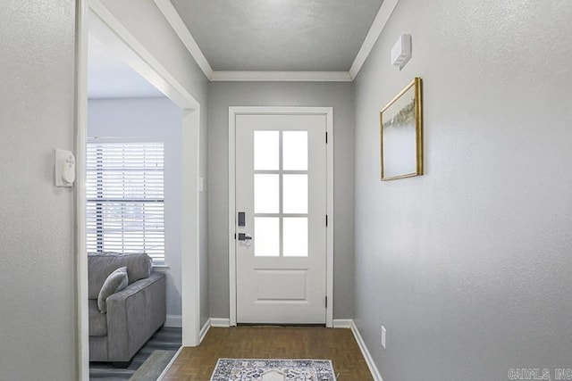 entryway featuring baseboards and ornamental molding