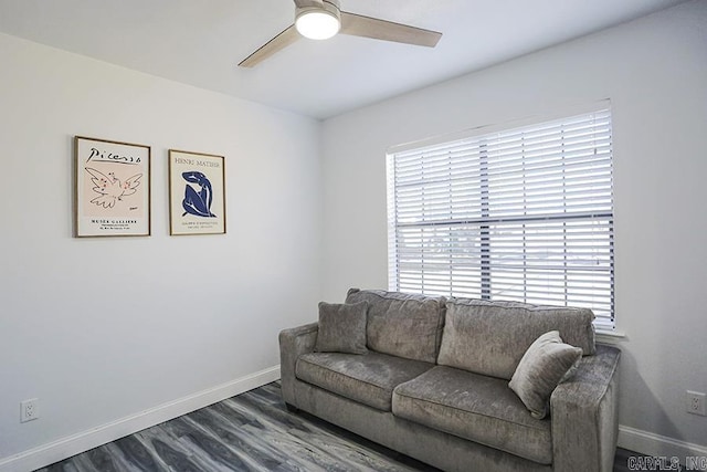 living room featuring a wealth of natural light, baseboards, and a ceiling fan