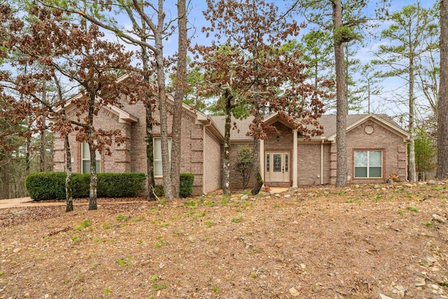 mid-century home with brick siding and roof with shingles