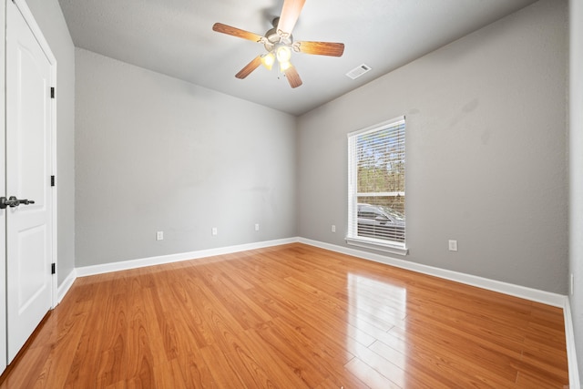 unfurnished room featuring visible vents, ceiling fan, baseboards, and light wood-style floors