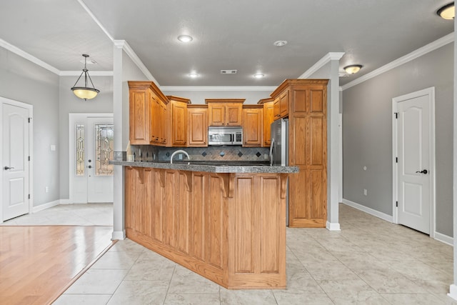 kitchen featuring dark stone counters, decorative backsplash, a peninsula, a kitchen breakfast bar, and stainless steel appliances