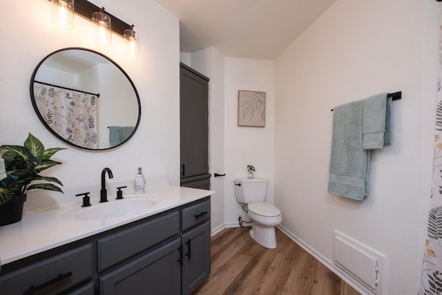 full bathroom featuring vanity, wood finished floors, visible vents, baseboards, and toilet