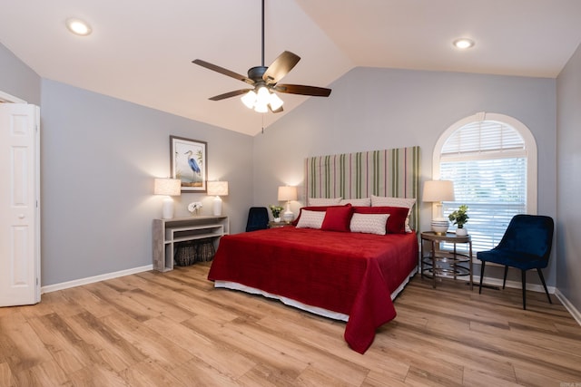 bedroom featuring ceiling fan, baseboards, light wood-type flooring, and lofted ceiling