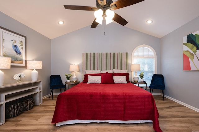 bedroom featuring vaulted ceiling, baseboards, and wood finished floors