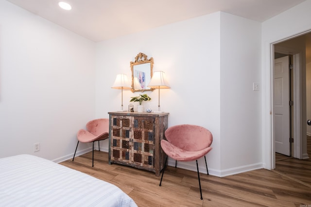 bedroom with recessed lighting, baseboards, and wood finished floors