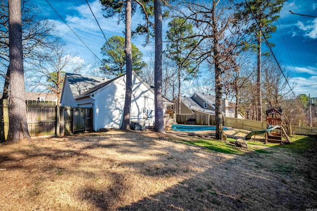 view of yard with a playground and a fenced backyard