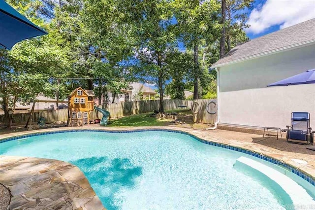 view of swimming pool with a fenced in pool, a patio, a playground, and a fenced backyard