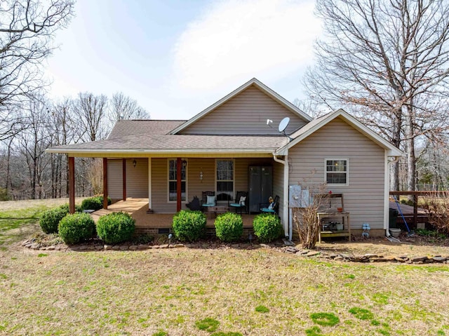 back of property featuring crawl space, covered porch, a lawn, and a shingled roof