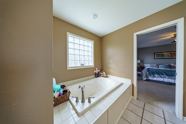 bathroom featuring tile patterned floors, connected bathroom, a garden tub, and ceiling fan