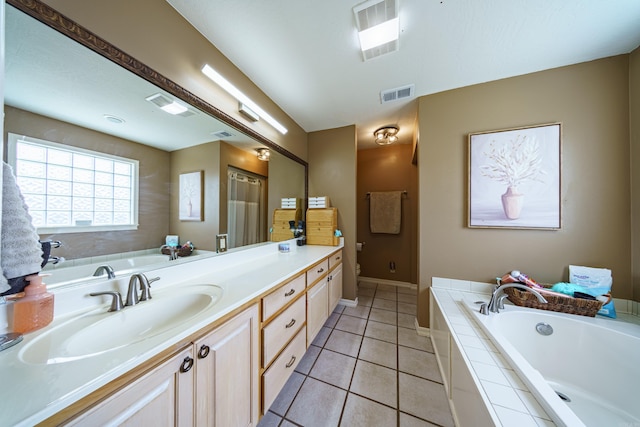 bathroom with tile patterned flooring, visible vents, a bath, and vanity