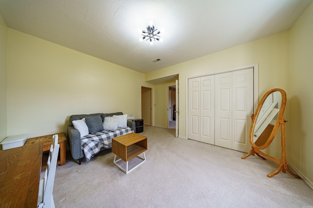 sitting room with light colored carpet and baseboards