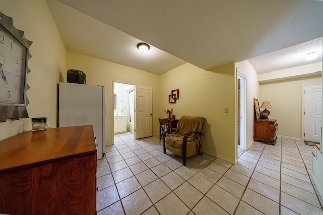 interior space with light tile patterned floors and baseboards