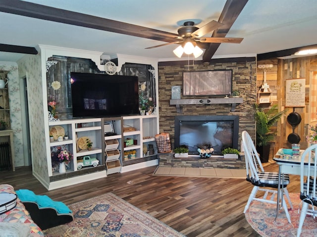 living room featuring ornamental molding, a fireplace, and wood finished floors