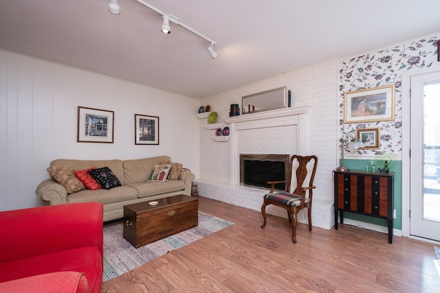 living room with a fireplace and wood finished floors