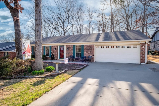 ranch-style house featuring brick siding, an attached garage, and driveway