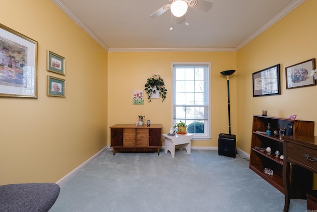 sitting room featuring carpet floors, ceiling fan, baseboards, and ornamental molding