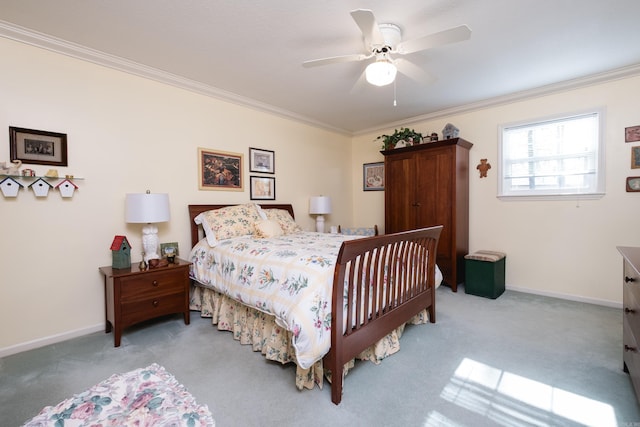 carpeted bedroom with a ceiling fan, baseboards, and ornamental molding