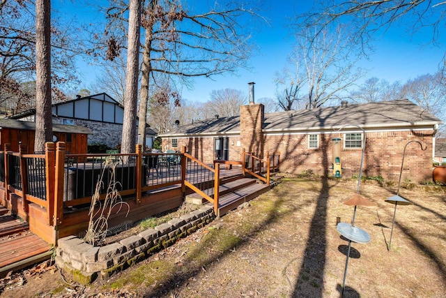 back of house featuring a wooden deck and brick siding