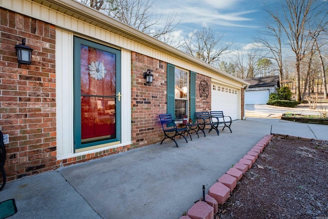 view of patio with an attached garage and driveway