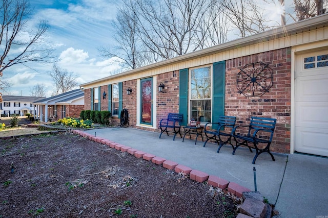 rear view of property featuring brick siding