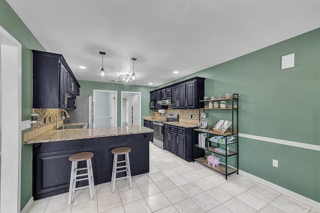 kitchen with a sink, light stone countertops, appliances with stainless steel finishes, a peninsula, and open shelves