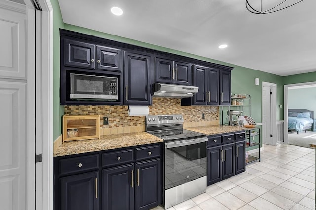 kitchen featuring light tile patterned floors, tasteful backsplash, under cabinet range hood, and stainless steel appliances