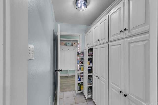 hall featuring light tile patterned flooring