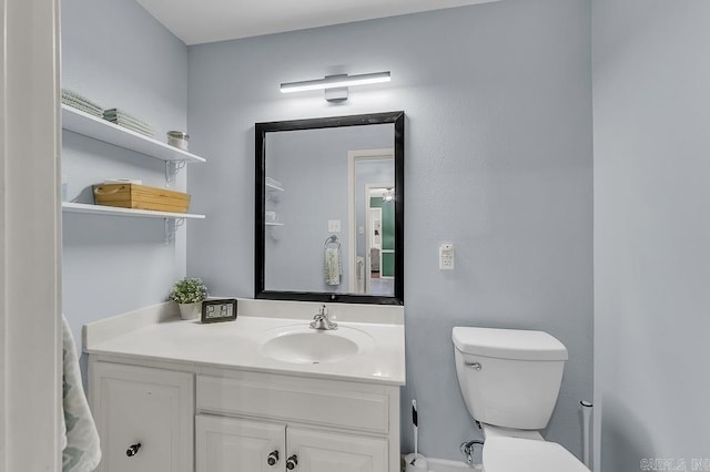 bathroom with toilet and vanity