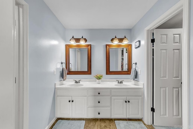 bathroom featuring a sink and double vanity