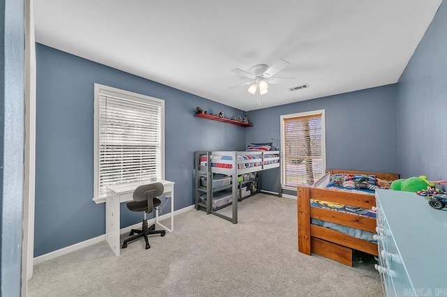 carpeted bedroom with visible vents, baseboards, and ceiling fan