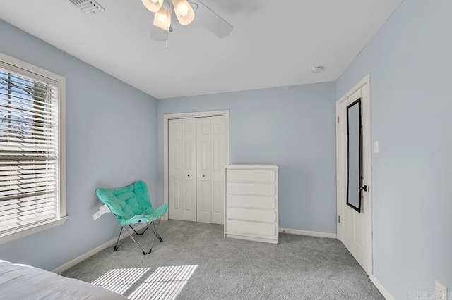 carpeted bedroom with a closet, visible vents, a ceiling fan, and baseboards