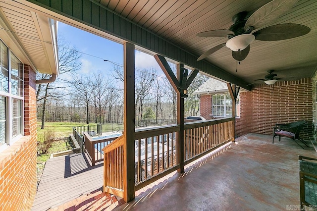 wooden terrace featuring ceiling fan