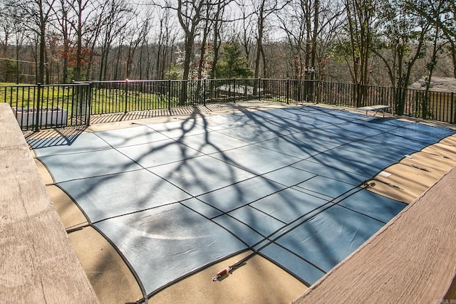 view of pool with a diving board