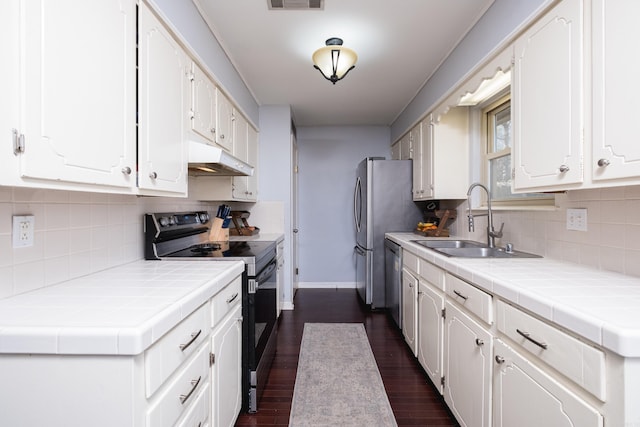 kitchen featuring a sink, under cabinet range hood, stainless steel dishwasher, black range with electric cooktop, and white cabinetry