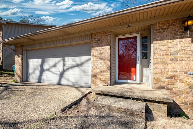 property entrance with brick siding and driveway