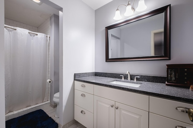 bathroom with vanity, a shower stall, and toilet