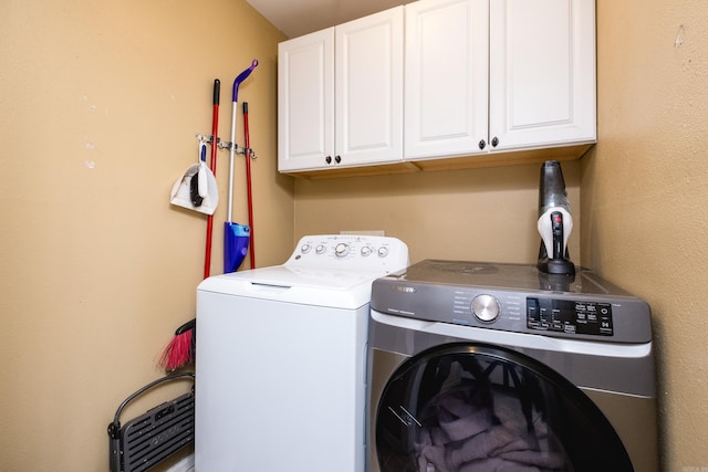 laundry room featuring cabinet space and separate washer and dryer