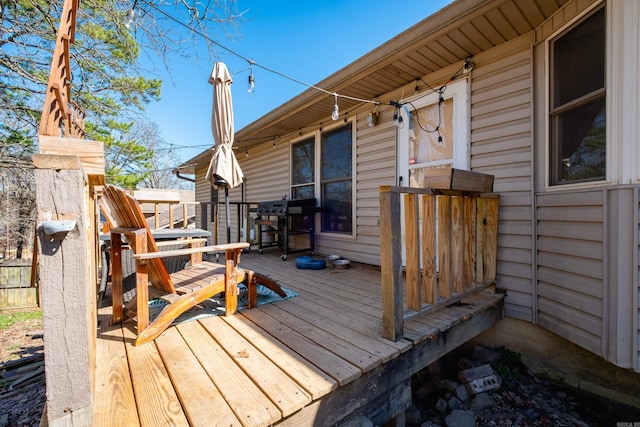 wooden terrace featuring a grill